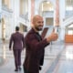 Andrew Tate (left) poses for a photo while entering the Court of Appeal on October 15, 2024 in Bucharest, Romania.