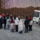 Immigrants wait to be transported by U.S. Border Patrol agents after crossing the U.S.-Mexico border on January 20, 2025 near Sasabe, Arizona.