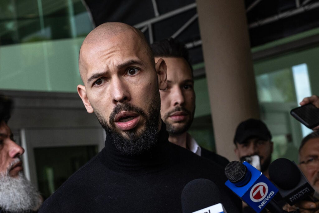 Andrew Tate (L) and Tristan Tate (R) arrive in the United States after a travel ban on them was lifted, at the Fort Lauderdale-Hollywood International Airport on February 27, 2025 in Fort Lauderdale, Florida.