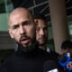 Andrew Tate (L) and Tristan Tate (R) arrive in the United States after a travel ban on them was lifted, at the Fort Lauderdale-Hollywood International Airport on February 27, 2025 in Fort Lauderdale, Florida.