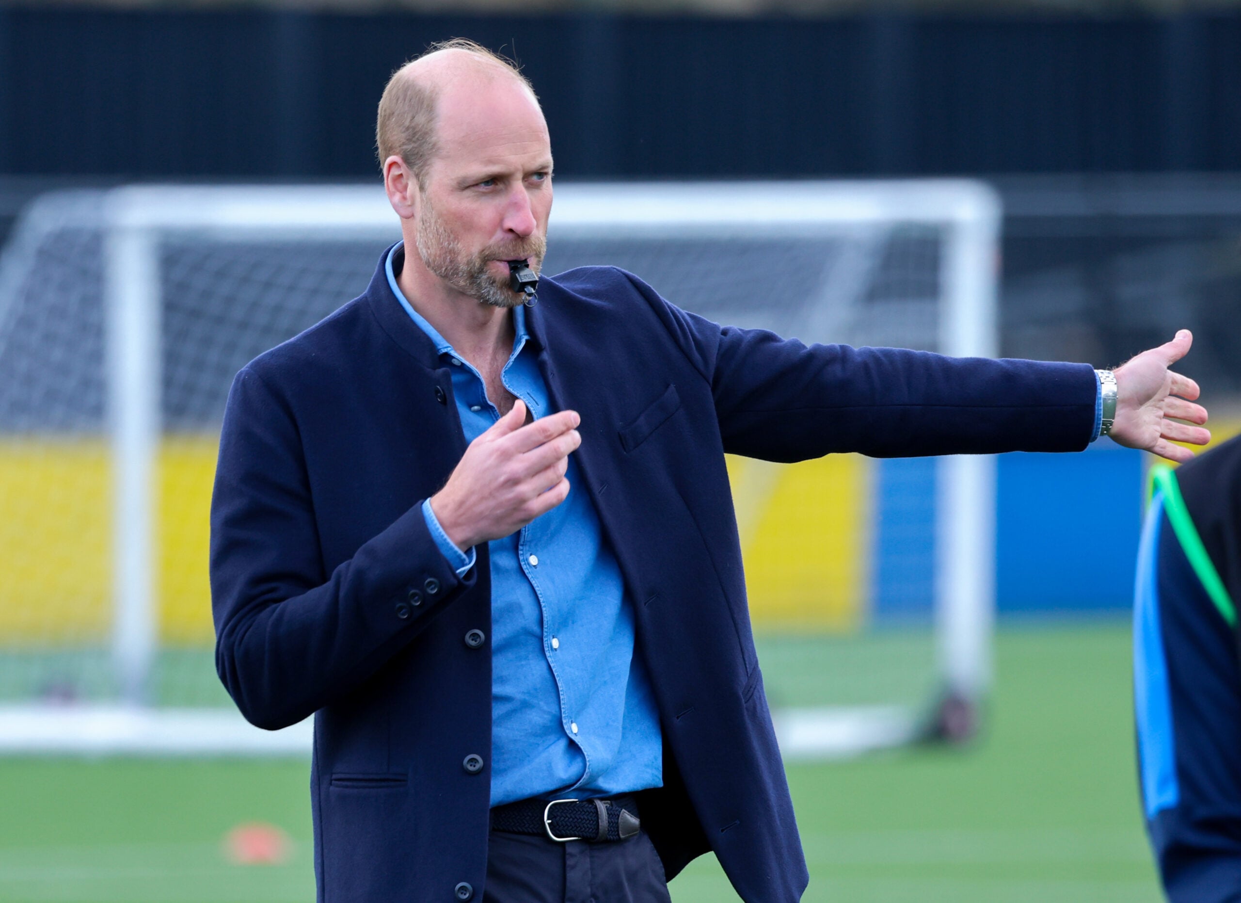 Prince William, Prince of Wales blows the referee's whistle during a mini football game on official visit to an FA Referee Training Course At Sporting Khalsa FC at Aspray Arena on March 11, 2025 in Willenhall, England.