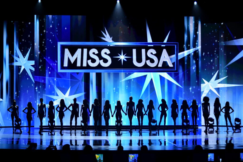 Miss USA 2024 in silhouette form on the stage.