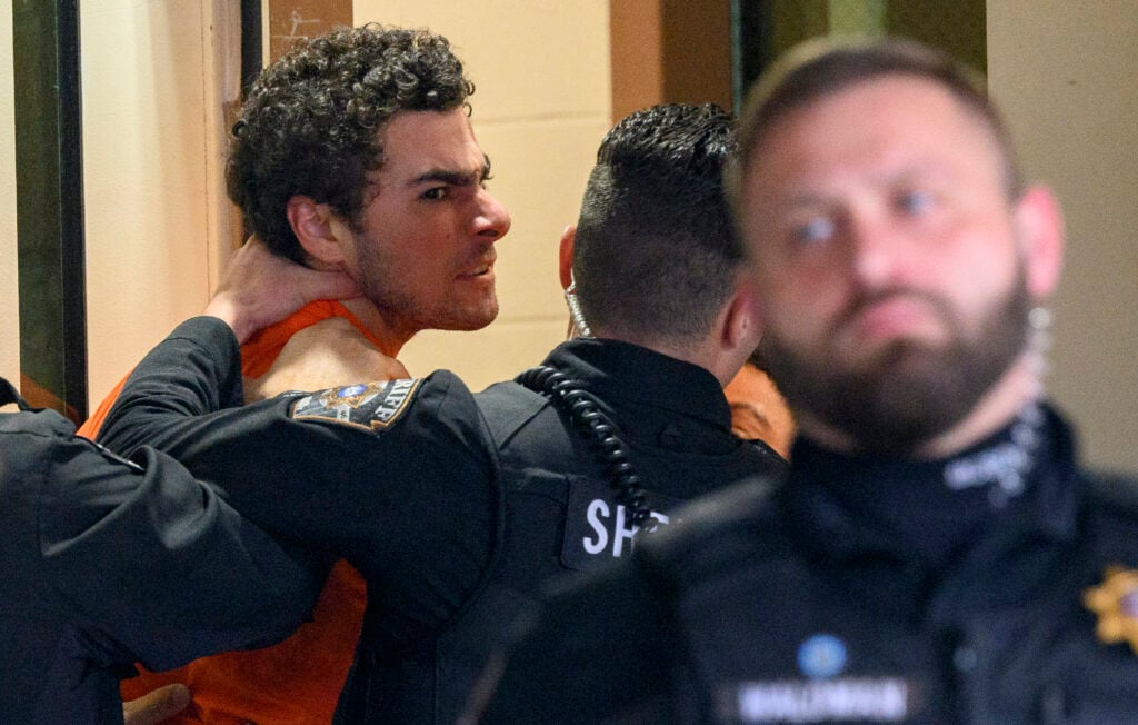 Suspected shooter Luigi Mangione is led into the Blair County Courthouse for an extradition hearing December 10, 2024 in Hollidaysburg, Pennsylvania. 