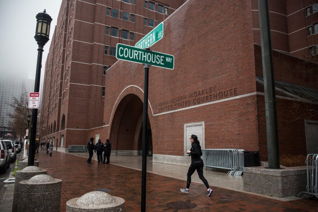 A runner jogs past the John Joseph Moakley United States Courthouse January 4, 2015 in Boston, Massachusetts.