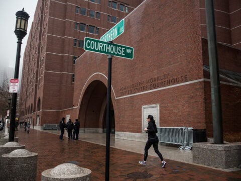 A runner jogs past the John Joseph Moakley United States Courthouse January 4, 2015 in Boston, Massachusetts.
