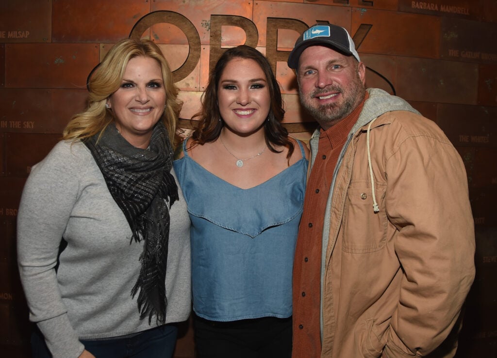 Singer/Songwriter Allie Colleen Brooks (center) Daughter of Garth Brooks and first wife Sandy Brooks poses with her stepmom Singer/Songwriter Trisha Yearwood and dad Singer/Songwriter Garth Brooks after making her Grand Ole Opry debut.