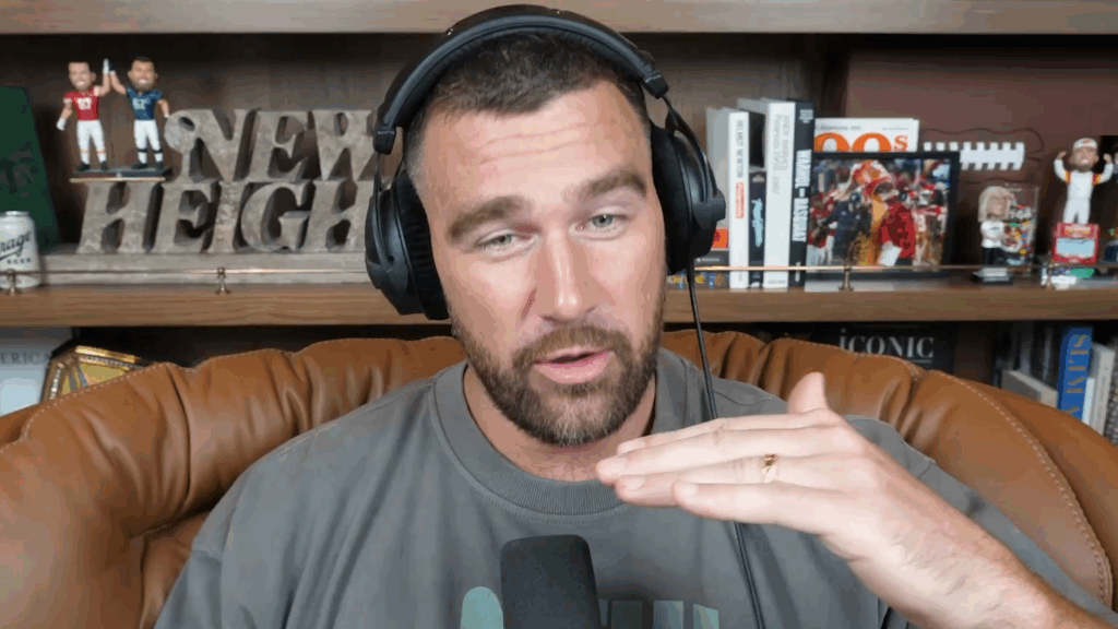 Travis Kelce displays his wedding ring on the 'New Heights' podcast.