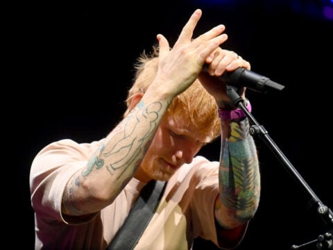 Ed Sheeran looks down while playing in December 2025.