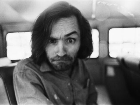 American criminal and cult leader Charles Manson (1934 - 2017) traveling on a police van to the Santa Monica Courthouse to appear in court for a hearing regarding the murder of music teacher Gary Hinman, Los Angeles, California, 25th June 1970.