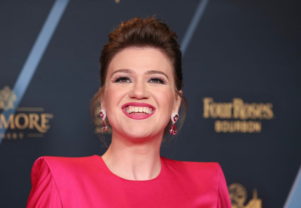 Kelly Clarkson flashes a toothy smile in June 2024.