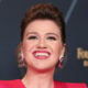 Kelly Clarkson flashes a toothy smile in June 2024.