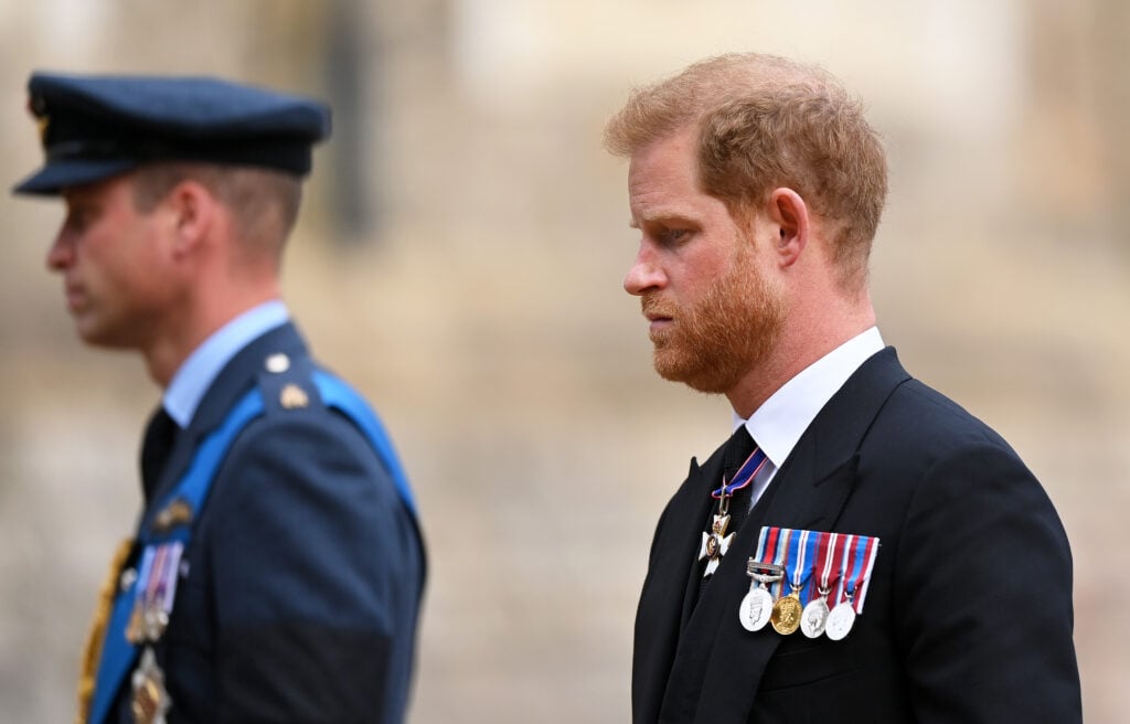 Prince William, Prince of Wales and Prince Harry, Duke of Sussex join the Procession following the State Hearse carrying the coffin of Queen Elizabeth II towards St George's Chapel on September 19, 2022 in Windsor, England. 