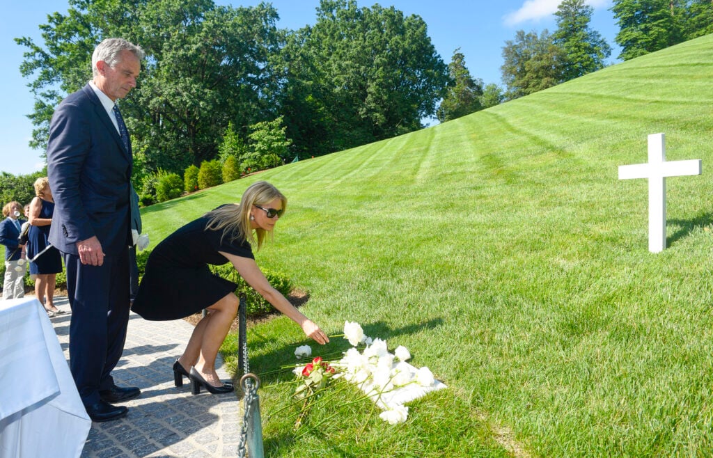 Robert F. Kennedy, Jr. and his wife Cheryl Hines place flowers on the marble tombstone marking the grave of Robert F. Kennedy during A Remembrace and Celebration of the Life & Enduring Legacy of Robert F. Kennedy at Arlington National Cemetery on June 6, 2018 in Arlington, Virginia. 